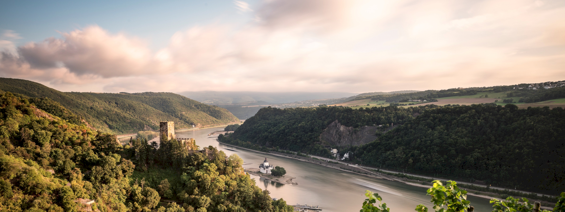 Beautiful German landscape with river, hills, village and castle.