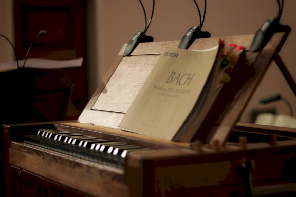 Piano with music sheets from Bach